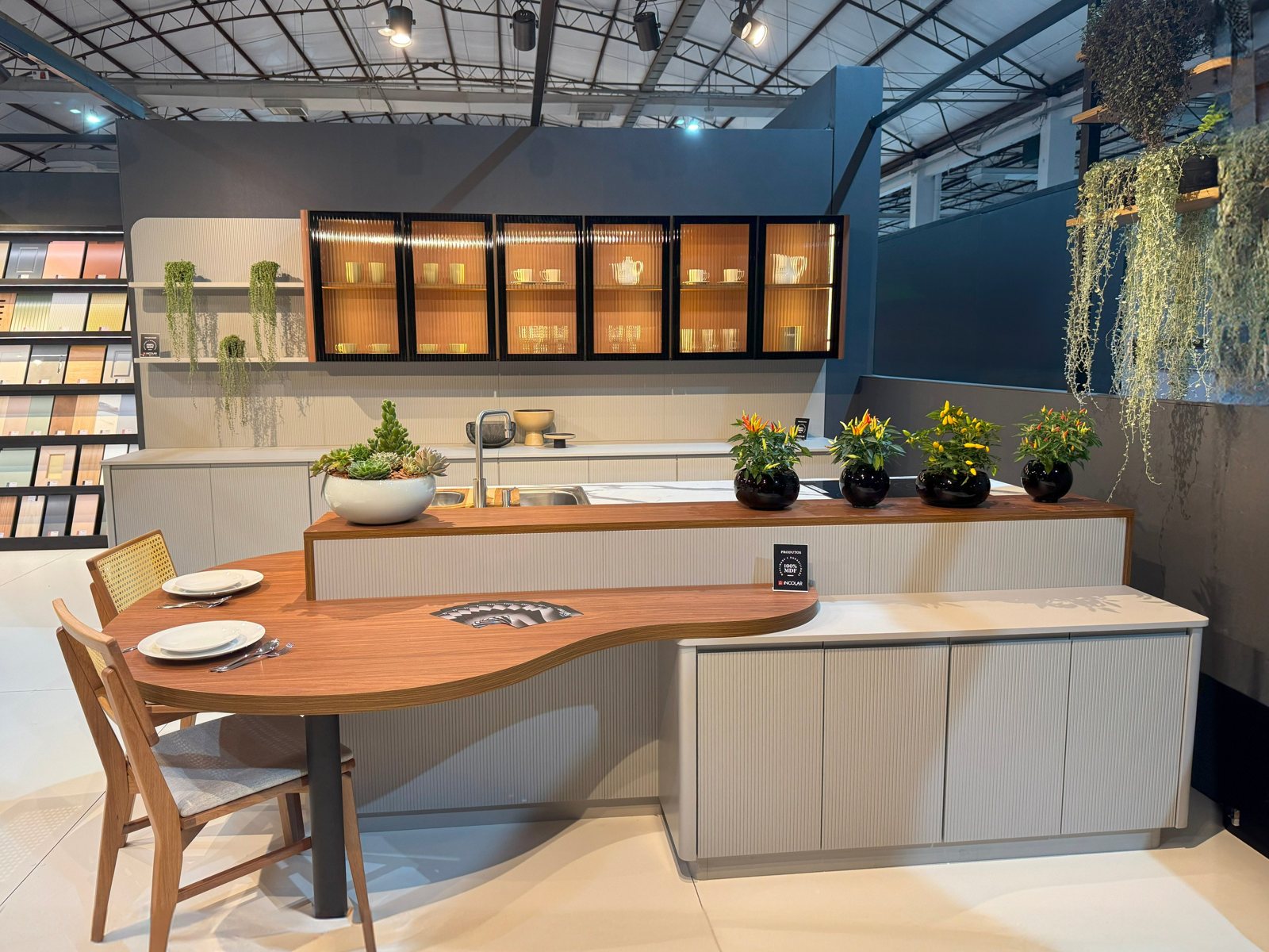 Cozinha com ilha curva e mesa em madeira